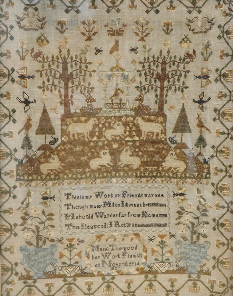 A finely worked sampler by Maria Thurgood, dated 14th November 1827. The sampler packed with finely embroidered motifs, the central motif of a large altar with lambs of God surrounded by motifs of birds, butterflies, rab